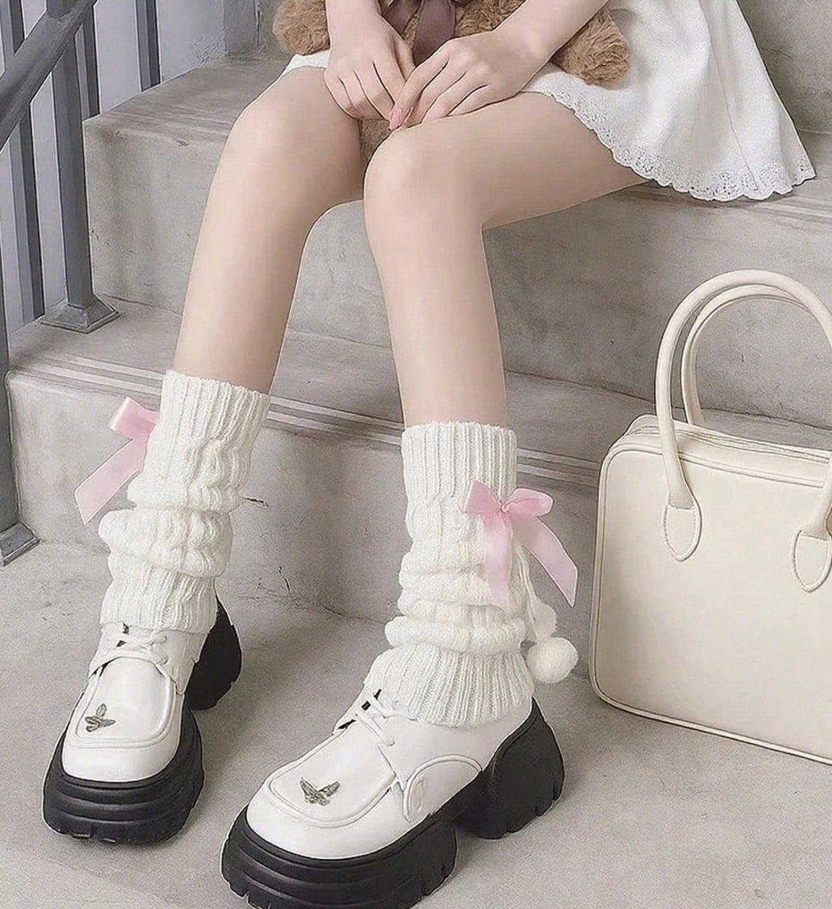 white flared leg warmers with pink bows