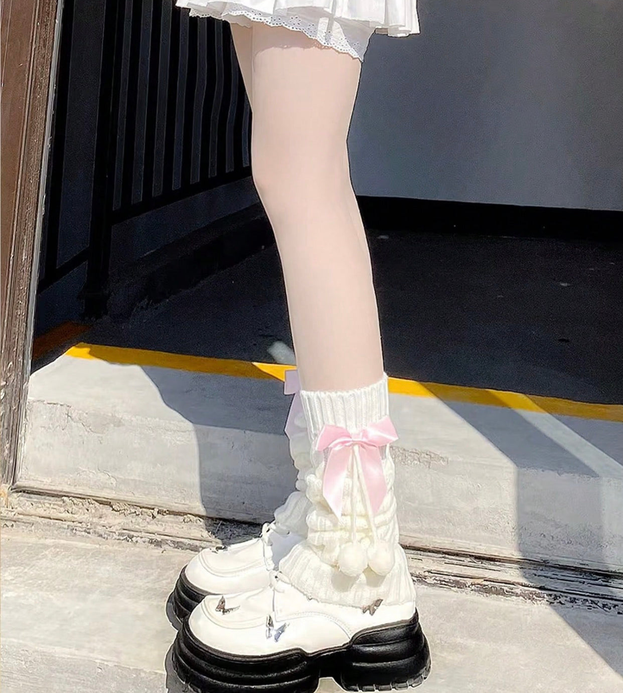 white flared leg warmers with pink bows