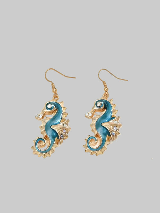 Pair of earrings with blue seahorse design on a white background
