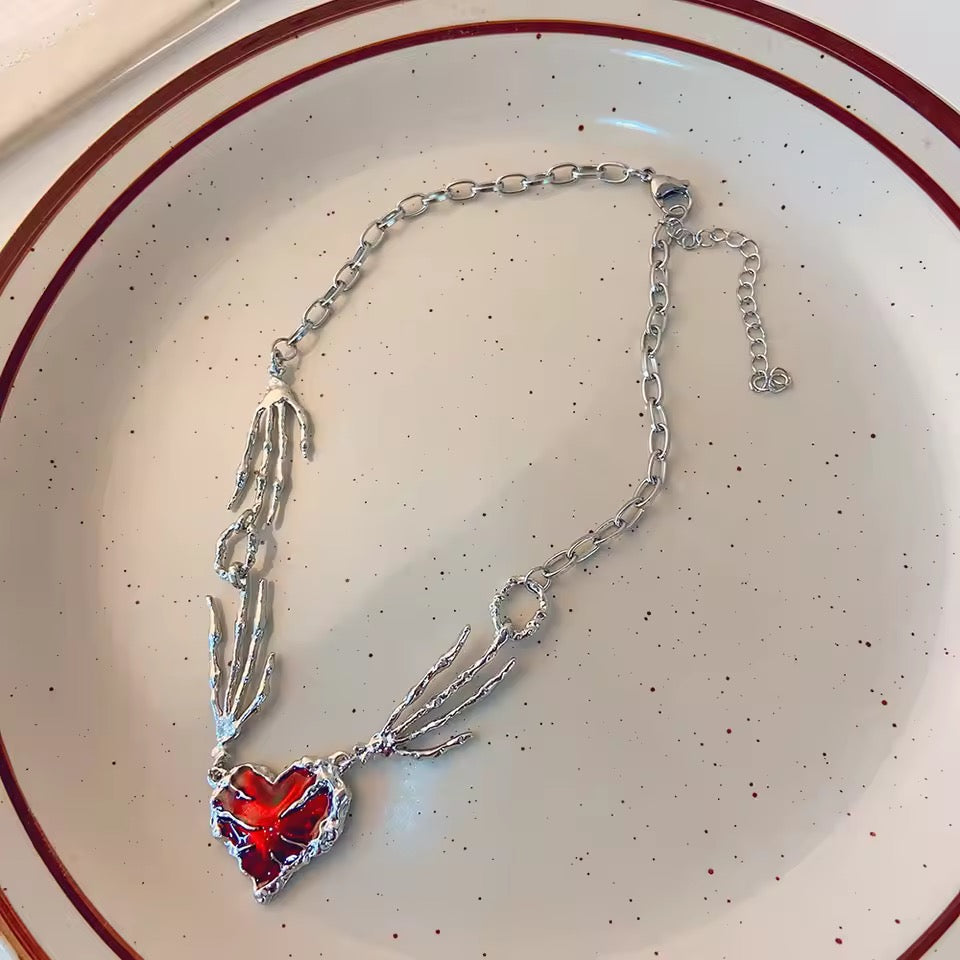 skull claw heart necklace