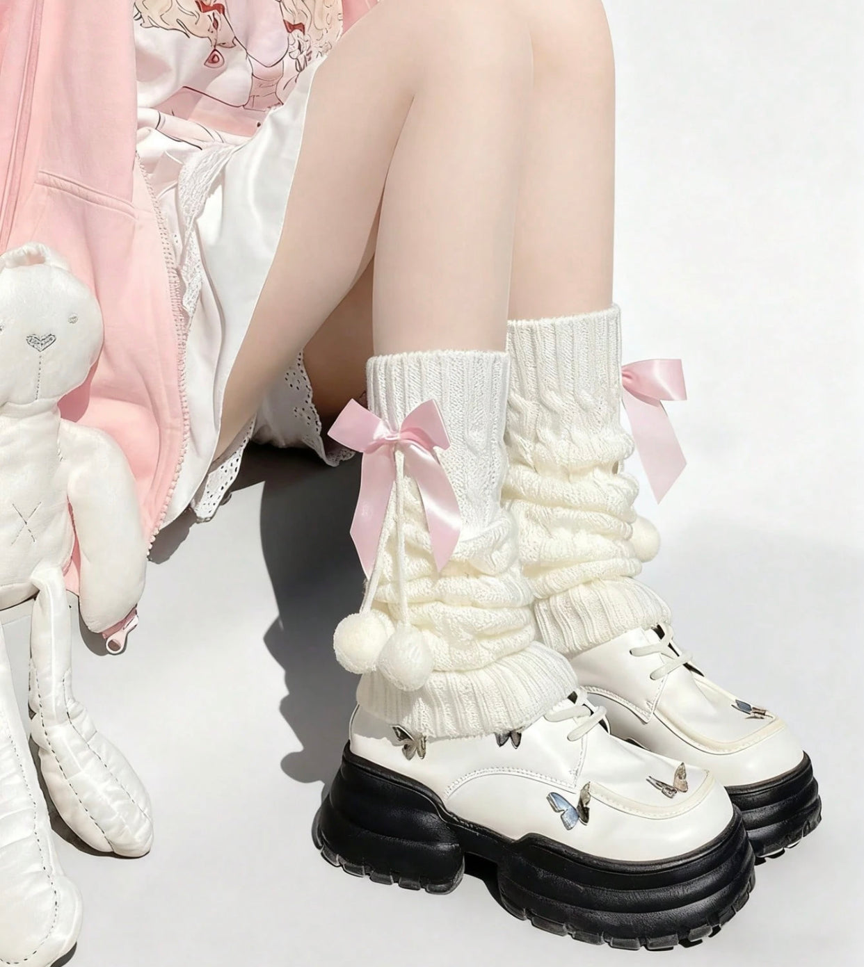 white flared leg warmers with pink bows
